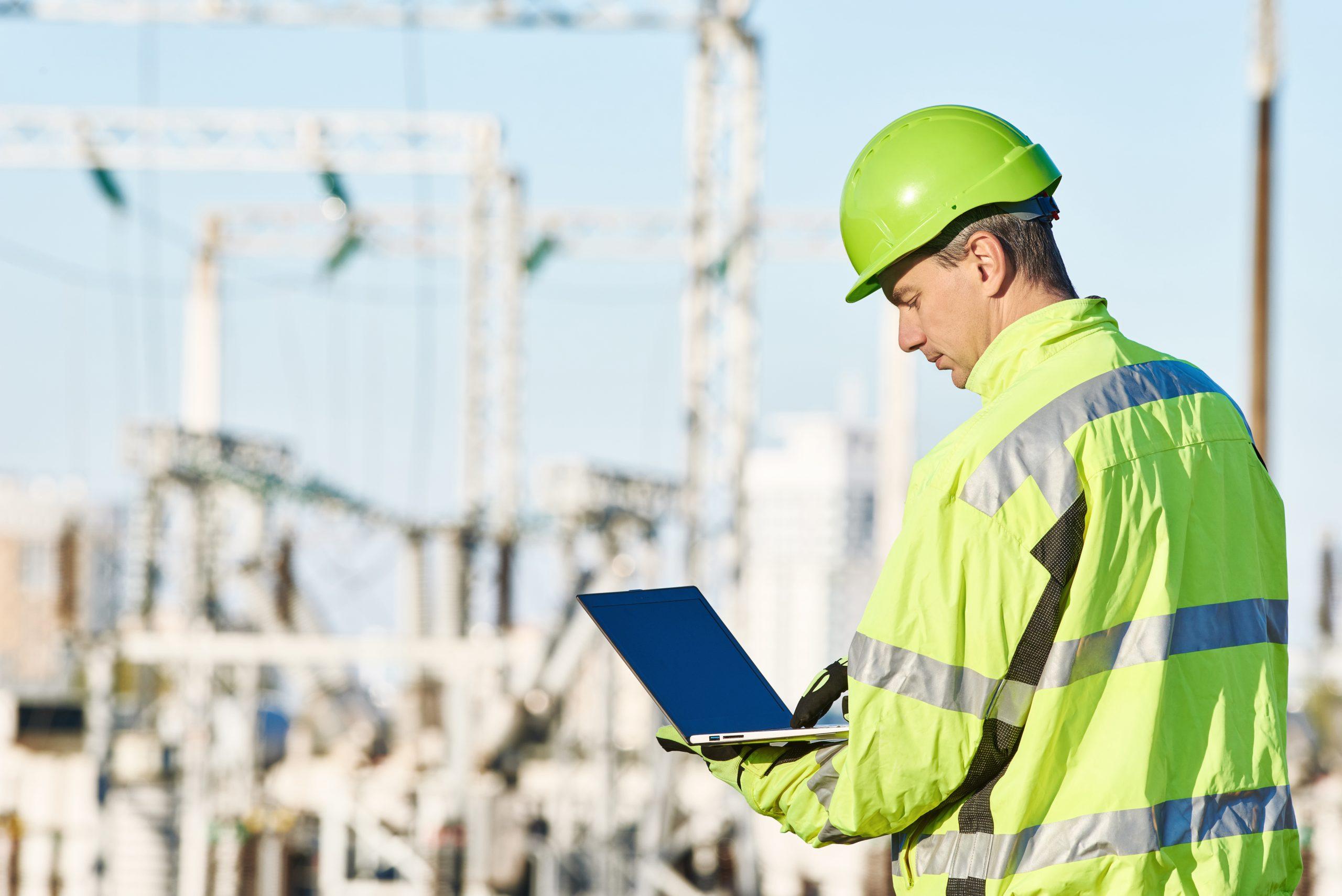 Engineer on site with laptop.