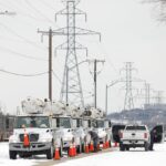 Electric Utility trucks parked in the snow amidst the Texas blackouts